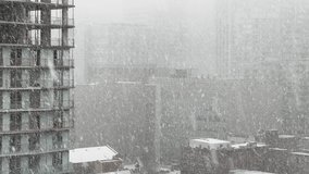 Buildings in heavy snowfall during winter day