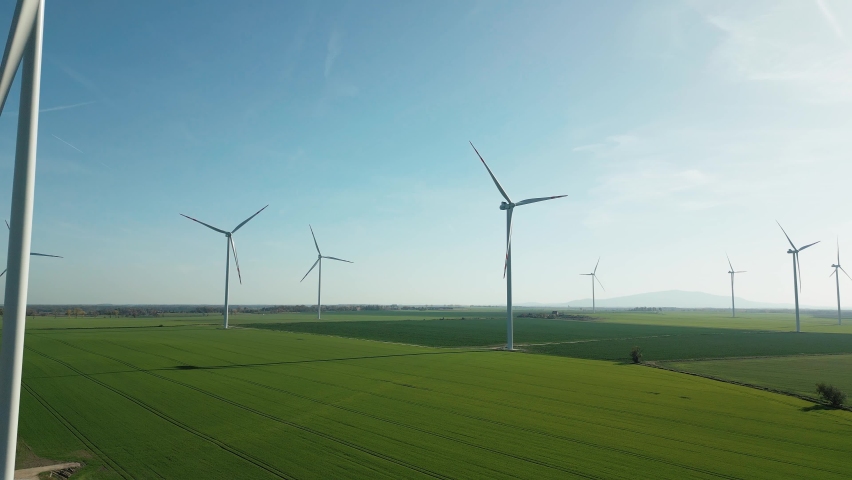 Green energy, wind turbines produce energy in the green field, modern power plant, alternative energy sources, quadrocopter flight. Royalty-Free Stock Footage #1096511425