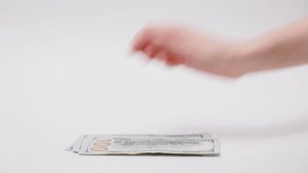Investments and deposits. Woman counts out American dollars and man puts small piggy bank on top of bills. Close-up of hands and money on white background. Concept of saving money. - Powered by Shutterstock - Get 15% off with code: PIKWIZARD15