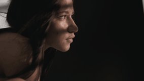 Portrait of young Native American woman in a dark studio light falls on her through the blinds. - Powered by Shutterstock - Get 15% off with code: PIKWIZARD15