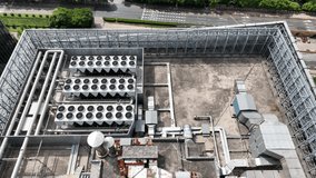 The air conditioner system on the building roof. Drone aerial view. Complicated air conditioning system on building top. Pipelines and machines. Industry, business, economy concept b-roll footage.