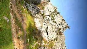VERTICAL VIDEO, Limestone rocks in the upland, agrarian grassland, morning