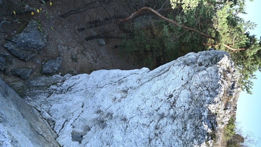 VERTICAL VIDEO, Limestone rocks in the highlands, autumn forest, sunny autumn day
