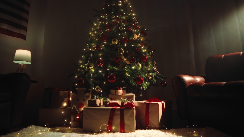 Christmas tree in a vintage house with sofas and gift boxes