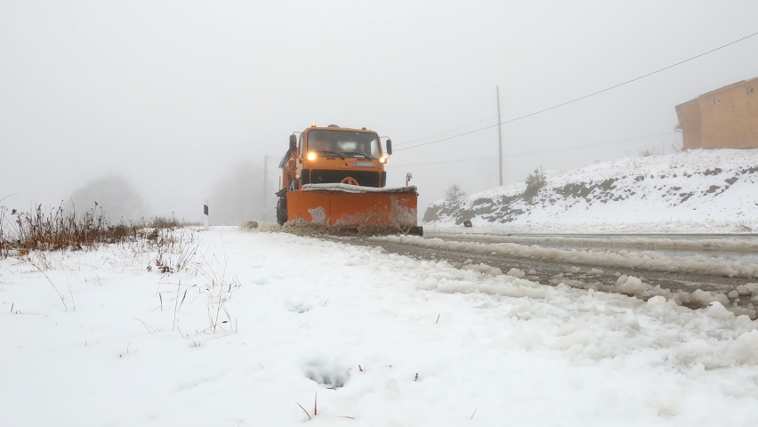 Front view of the snow plow cleans the mountain road from snow. Royalty-Free Stock Footage #1096532457