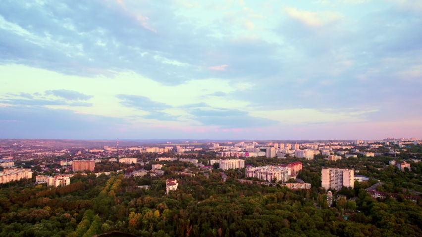 Panoramic filming of a city edge during a wonderful sunset with clouds. Aerial video. 4K Royalty-Free Stock Footage #1096535803