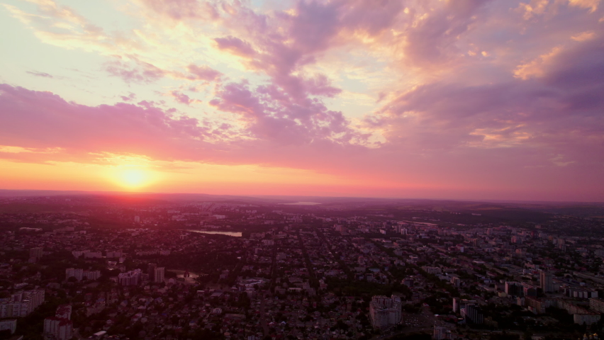 Sunset lit with color, which fills the whole city with energy, reflecting the red light everywhere. Drone video. 4K. Royalty-Free Stock Footage #1096535805