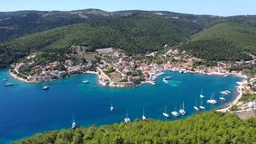 Aerial drone video from iconic picturesque fishing village and bay of Fiskardo with beautiful traditional houses of Ionian architecture, Cefalonia island, Greece
