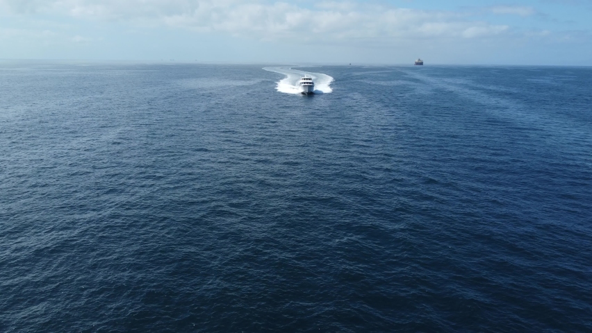 Long Beach Aerial of Expensive Super Yacht flying through the Pacific Ocean. Drone 4k