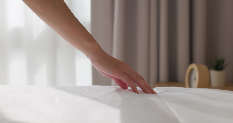 slow motion close up asian woman dragging her hand on clean white bed gently at home  relaxing soft comfortable concept Royalty-Free Stock Footage #1096545937