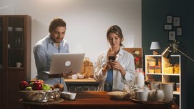 Young husband and wife talking on virtual conference while cooking family breakfast or dinner together in cozy kitchen. Woman speaking on video call on laptop. Romantic relationships.