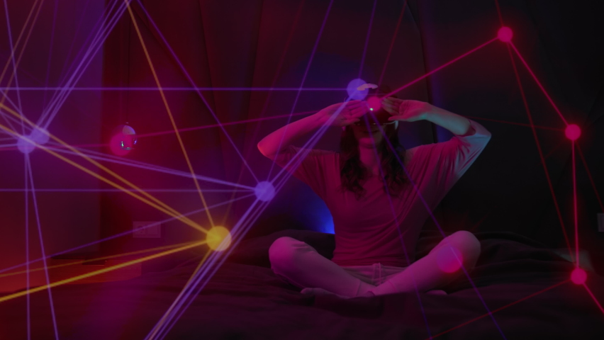 Young Woman Using Virtual Reality Headset And Looking Around On Colorful Illumination.Tech Entertainment concept VR Futuristic Royalty-Free Stock Footage #1096550845