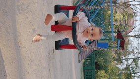 4k slow motion video of baby enjoying while swinging on swing at outdoor playground, healthy lifestyle