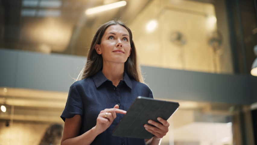 Female Data Analyst Smiling While Checking New Data for the Day. Portrait of White Businesswoman Walking Towards her Business Office in a Spacious Corporate Building. Low Angle, Slow Motion Royalty-Free Stock Footage #1096559175