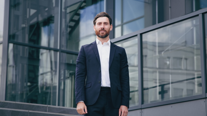Successful confident businessman professional manager leader standing with arms crossed near corporate office building handsome smiling bearded caucasian man model posing outdoors in business center Royalty-Free Stock Footage #1096561167