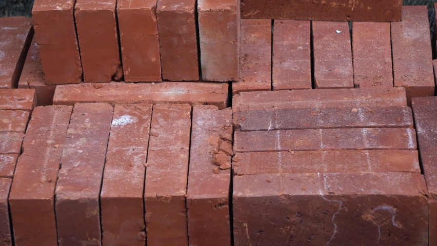 Temanggung, Indonesia - September 2022 : Stacks of red bricks arranged horizontally and vertically. Perfect for background, film, documentation, education, ect.