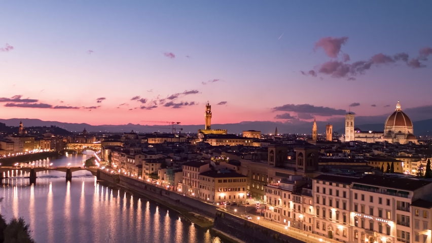 Aerial panoramic view of Florence Cathedral, Firenze Cattedrale di Santa Maria del Fiore, Ponte Vecchio and Arno River on a beautiful colourful sunset sky, Tuscany region of Italy Florence Royalty-Free Stock Footage #1096565473
