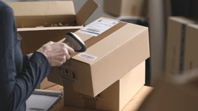 Hands of woman scanning barcode on delivery parcel. Worker scan barcode of cardboard packages before delivery at storage. Woman working in factory warehouse reading and scanning labels on the boxes. - Powered by Shutterstock - Get 15% off with code: PIKWIZARD15