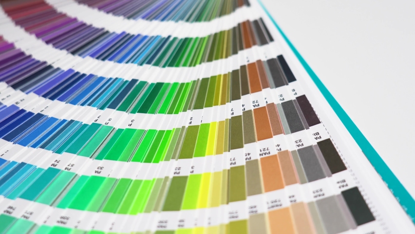 The graphic designer chooses colors from the color palette guide. 

Discover the best Pantone colors Royalty-Free Stock Footage #1096567669