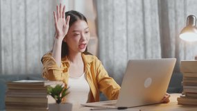 Young Asian Female Raising Her Hand To Ask Question While Studying On A Laptop At Home
 - Powered by Shutterstock - Get 15% off with code: PIKWIZARD15