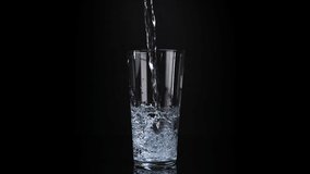 Filling a glass of water on black background. Healthy and fresh water. Slow motion - Powered by Shutterstock - Get 15% off with code: PIKWIZARD15