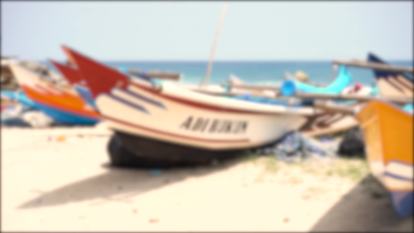 Yogyakarta, Indonesia - November 2022 : Close up boat blur video showing leaning on the beach on blue sea background. Perfect for background, film, documentation, education, ect.