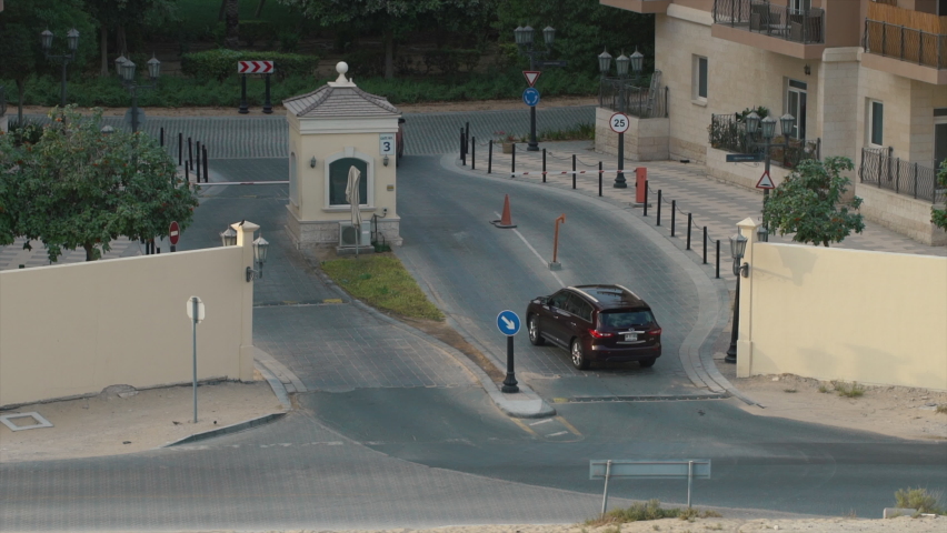 automobile checkpoint in a residential area. dubai suburbs, cars drive into the area. High quality 4k footage