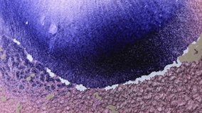 Slow motion, close up video design suitable for music or advertising. Shimmering movement of purple paint. Bubbling stream of a lilac