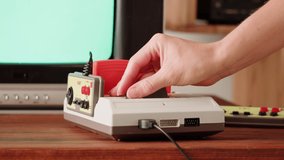 Old TV Game Console with ROM Cartridge, Vintage Gamer Room Joystick and Retro TV, Man Player Start the Game, Play. - Powered by Shutterstock - Get 15% off with code: PIKWIZARD15