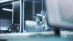 Industrial Programmable Robotic Arm in a Factory Development Facility. Robot Arm Holding a Prototype Microchip. Tech Office with Machines, Computers and Research Equipment. Footage Without People. - Powered by Shutterstock - Get 15% off with code: PIKWIZARD15