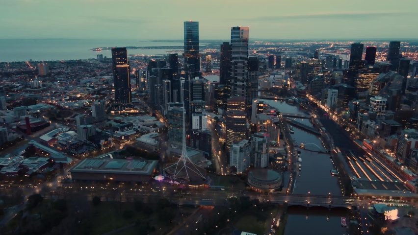 Aerial drone pullback reverse view of Melbourne City, Victoria, Australia above the Yarra River in the very early morning at dawn 