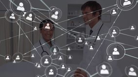 Animation of network of connections with icons over diverse doctors. Global connections, medicine and digital interface concept digitally generated video. - Powered by Shutterstock - Get 15% off with code: PIKWIZARD15