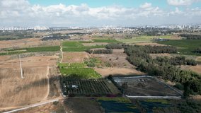 4k drone video- open agricultural fields in the distance the view of the city of Ramla- Israel