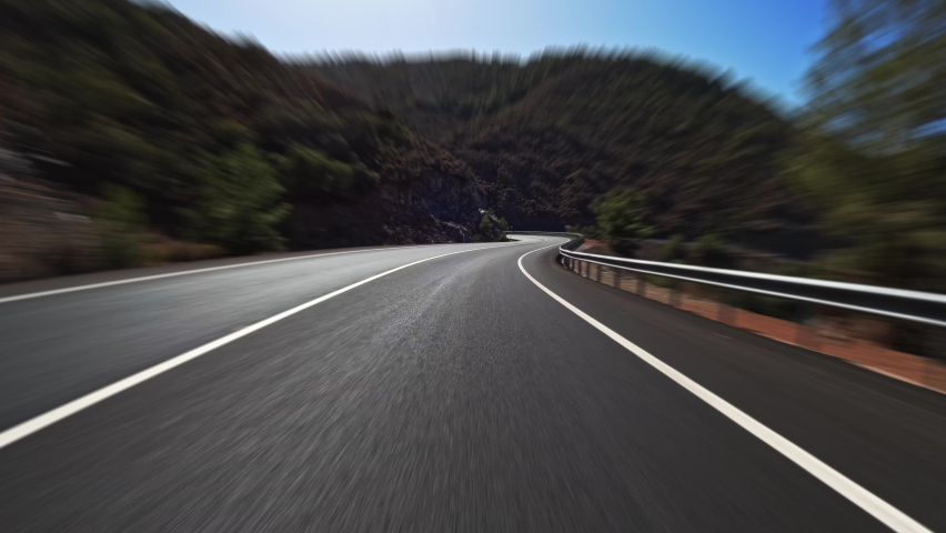 Timelapse of a mountain road with black asphalt and fresh white markings. Travel by car, first-person view. POV transportation drive forward. Royalty-Free Stock Footage #1096606705