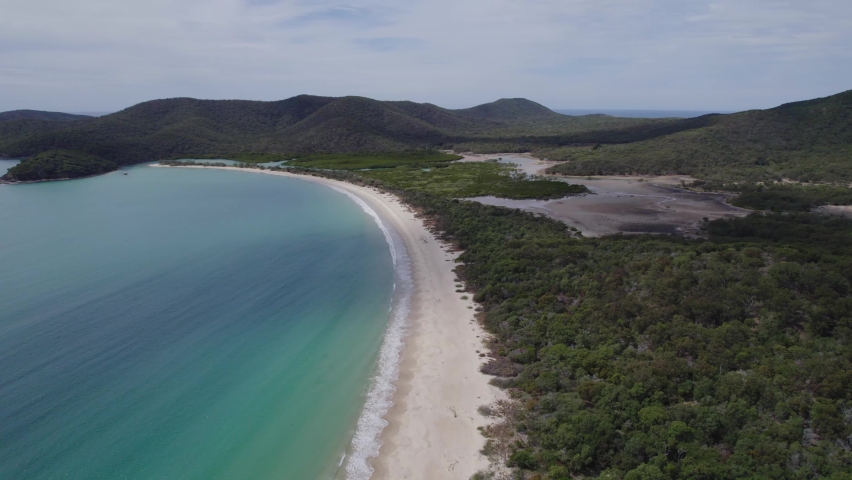 Scenic Beach With Turquoise Sea Waves Splashing On Shore At Great Keppel (Wop-pa) Island In Queensland, Australia - aerial drone shot