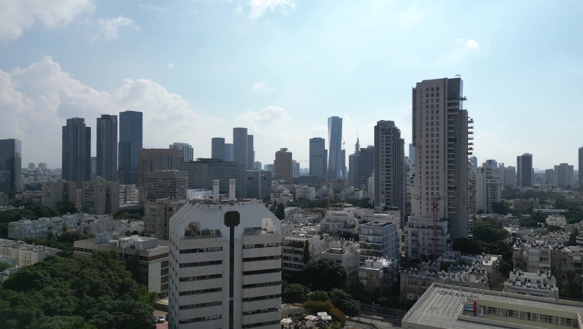 Tel Aviv skyline drone shot. Israel TLV skyscrapers all over city center. Expensive real estate. middle east high-tech startup nation. Tall buildings roads cars and the sea. Tel Aviv beach. blue sky
