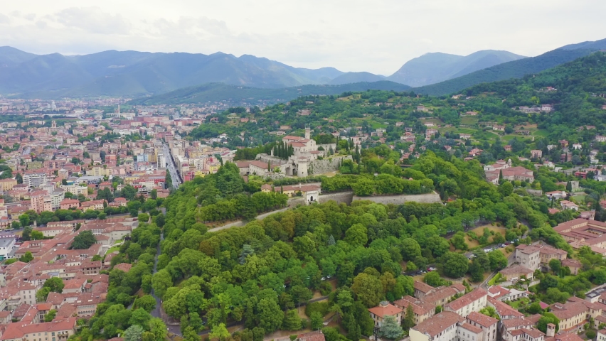 Inscription on video. Brescia, Italy. Castello di Brescia. Flight over the city in cloudy weather. Text furry, Aerial View, Point of interest