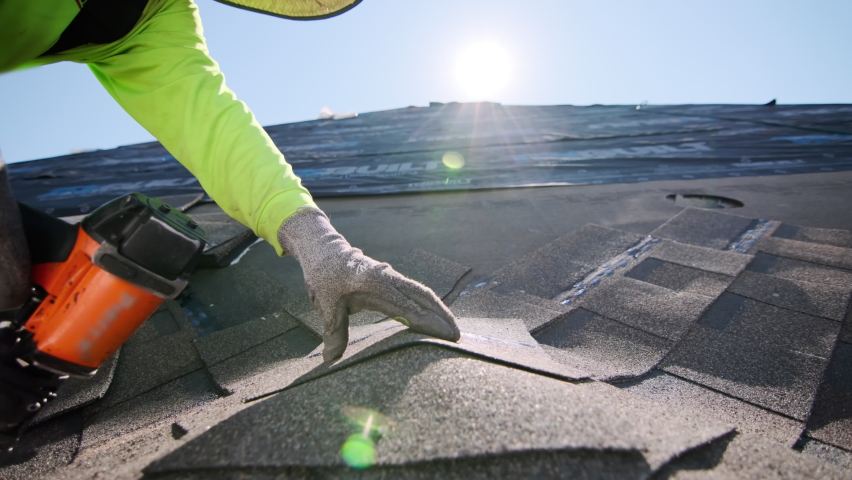 Close up footage of Roofer repair or replace shingle that has been damaged and needing replacement at sunny day.  | Shutterstock HD Video #1096613513
