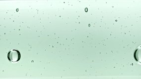 Transparent Cosmetic Gel Fluid With Molecule Bubbles and Oil Flowing in Glass Tube with Clear Liquid on White Background. Macro shot. Production Close-up. Slow Motion. - Powered by Shutterstock - Get 15% off with code: PIKWIZARD15