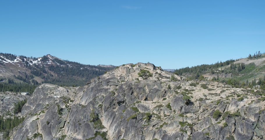 Aerial revealing over Granite cliffs to mountains on Donner Pass, California in summer