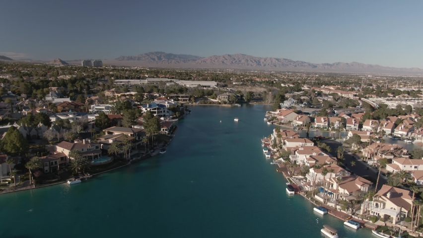 Low aerial above lakefront homes in West Sahara gated community is Las Vegas