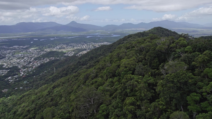 Green Mountains Surrounding Cairns City In Far North Queensland, Australia - aerial drone shot