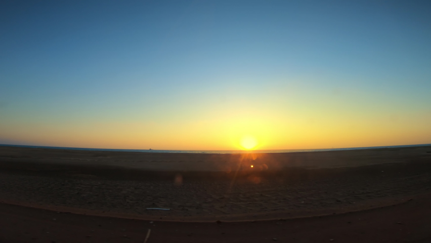 View from scenic drive on the road along the seaside at orange sunrise