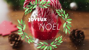 Animation of joyeux noel text over candy canes and decorations on wooden background. Christmas, tradition and celebration concept digitally generated video. - Powered by Shutterstock - Get 15% off with code: PIKWIZARD15