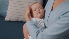 Close up portrait of newborn baby sleeping in mother's arms. Mom touch head child. Motherhood. Childhood. Mom holds the hand child. Slow motion - Powered by Shutterstock - Get 15% off with code: PIKWIZARD15
