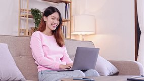 Asian female student Sit and work and study online on the sofa at home.