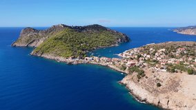 Aerial drone video of beautiful colourful and picturesque small fishing coastal village of Assos in island of Kefalonia, Ionian, Greece