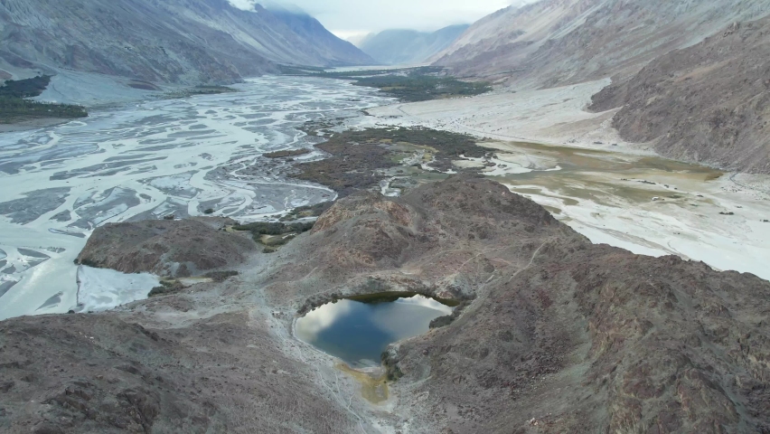 Aerial view of Tso Yarab Lake -  Hidden Buddhist Sacred. Himalaya mountains range. India, Ladakh, near in Nubra Valley. | Shutterstock HD Video #1096654435
