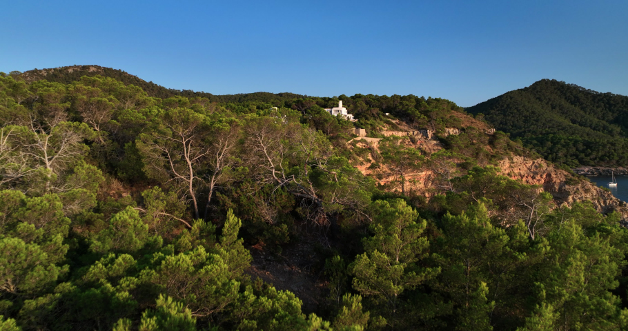 Aerial view of Ibiza coastline in Spain. Luxury villa on the top of the rocky hill.