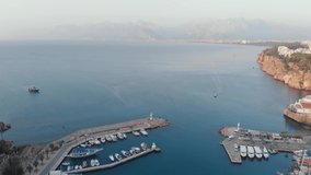 A beautiful shot of a sea bay with boats for a travel video. A bay in the Old Town of Antalya. Aerial view. High quality 4k footage